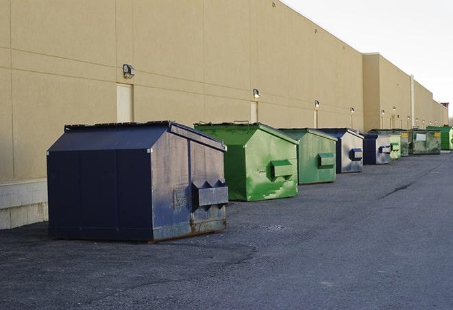 a group of construction workers taking a break near a dumpster in Adell, WI